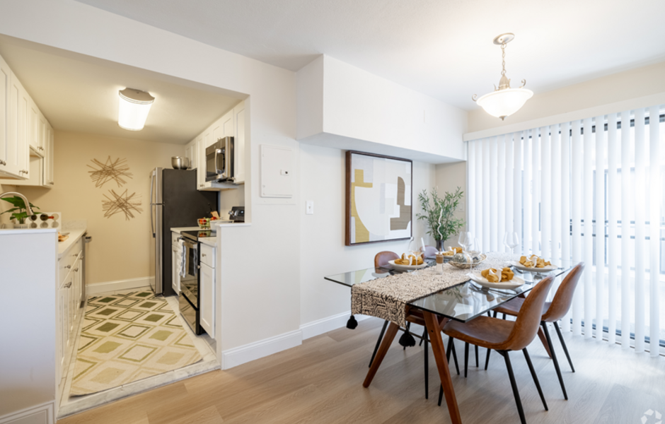 Dining room with kitchen in the background