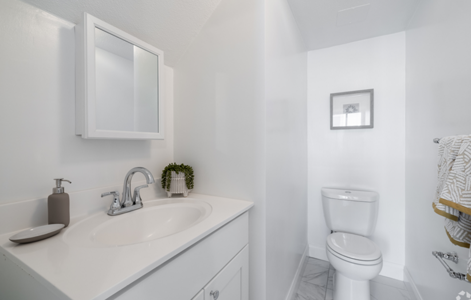 White bathroom with sink and toilet