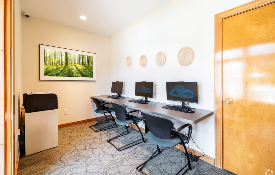 Business center with computers, desk chairs, and wall decorations